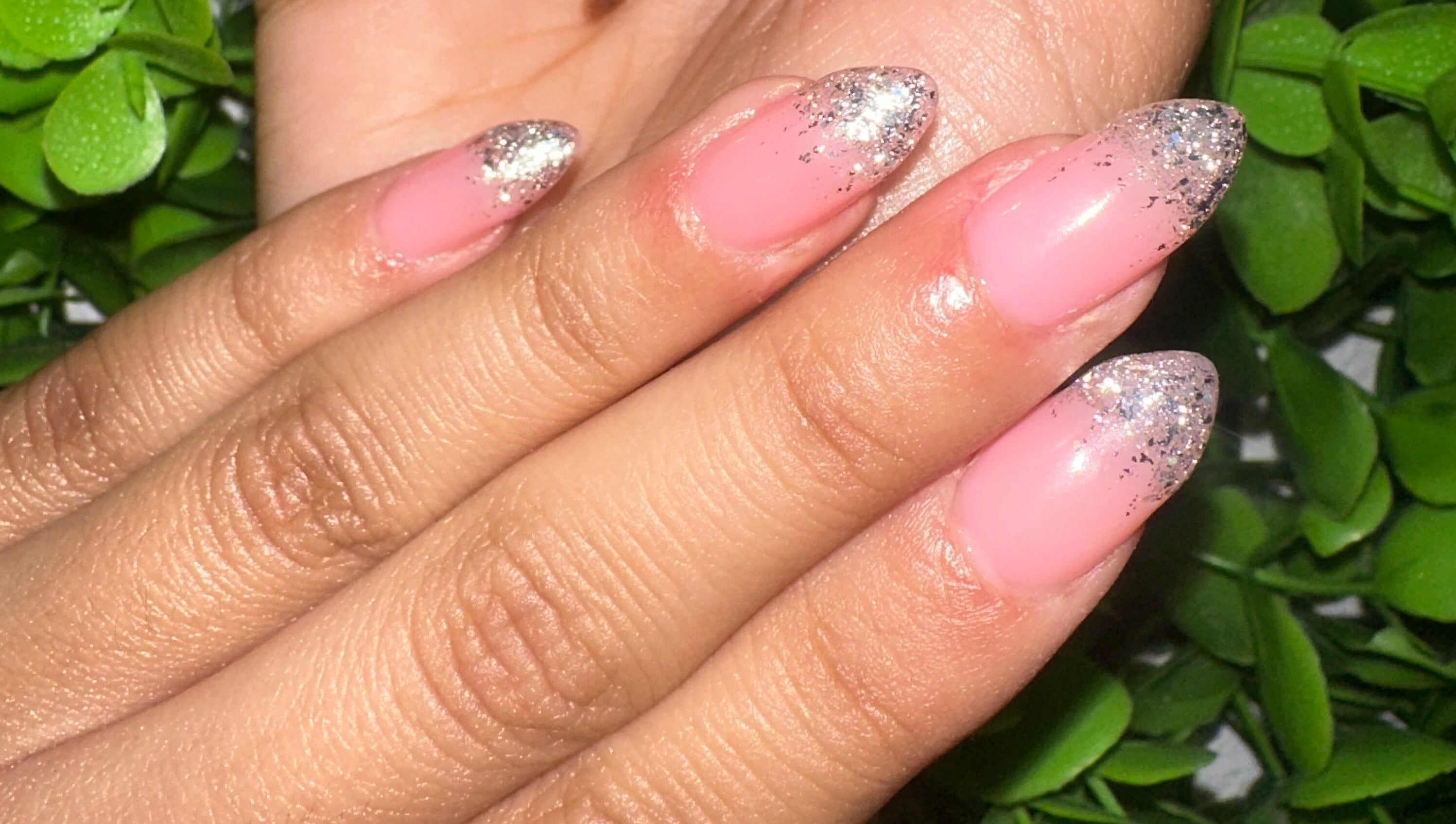 Glittery pink manicure at Lovely Me Nail Studio, Laredo, Texas, US.
