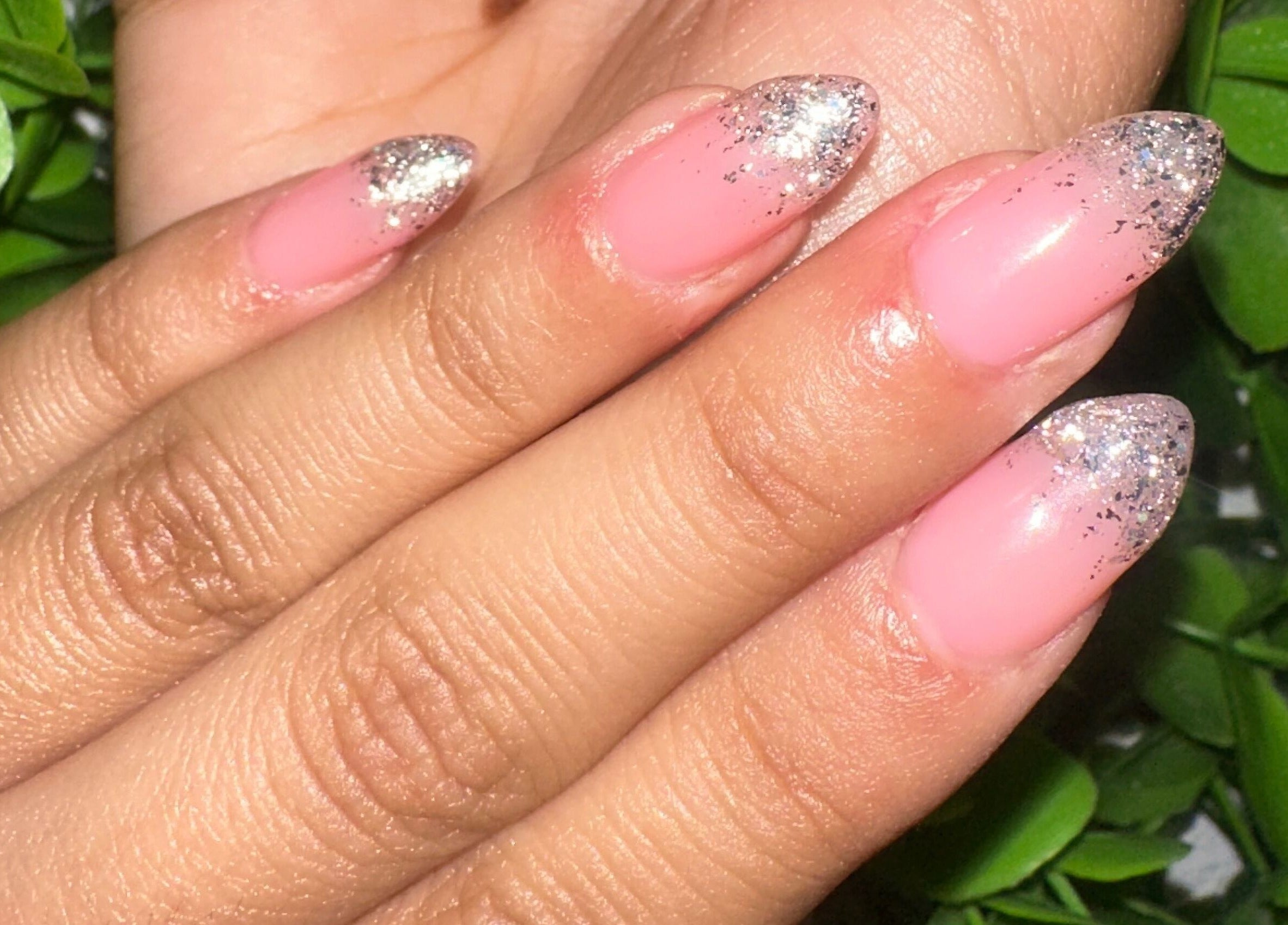 Glittery pink manicure at Lovely Me Nail Studio, Laredo, Texas, US.