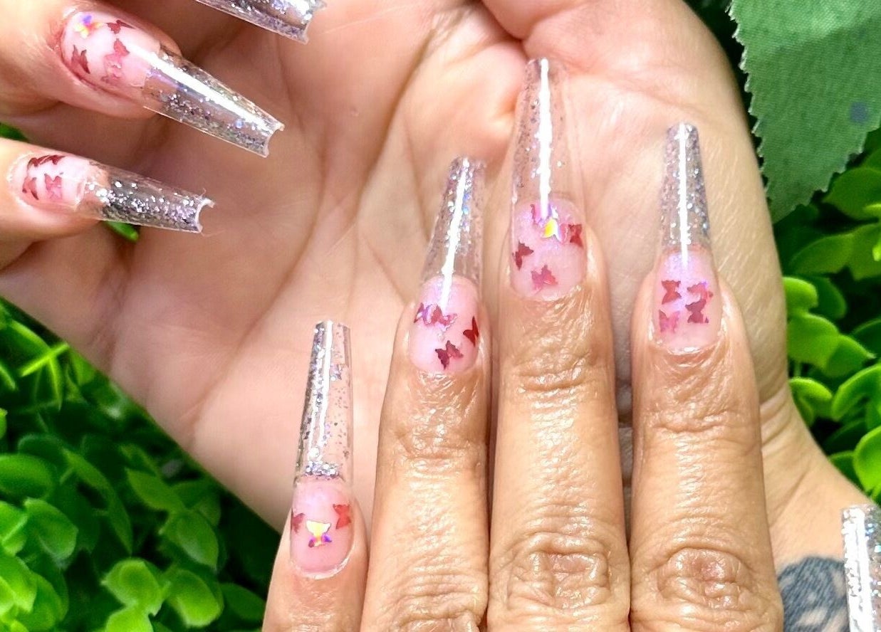 Intricate butterfly nail art at Lovely Me Nail Studio, Laredo, Texas, US showcasing elegance and style.