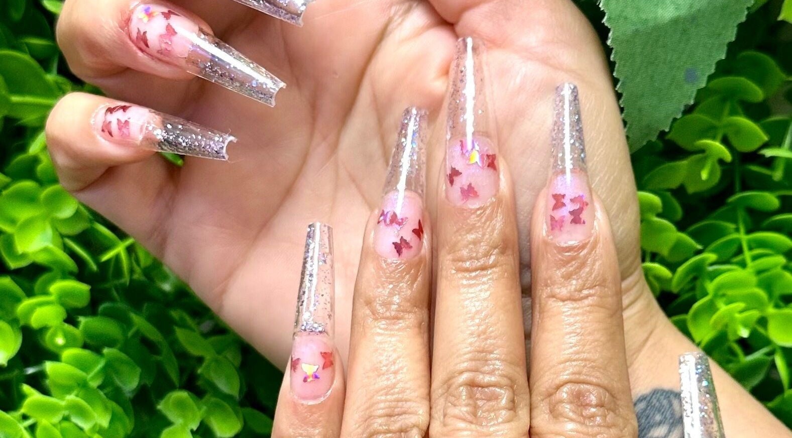 Intricate butterfly nail art at Lovely Me Nail Studio, Laredo, Texas, US showcasing elegance and style.