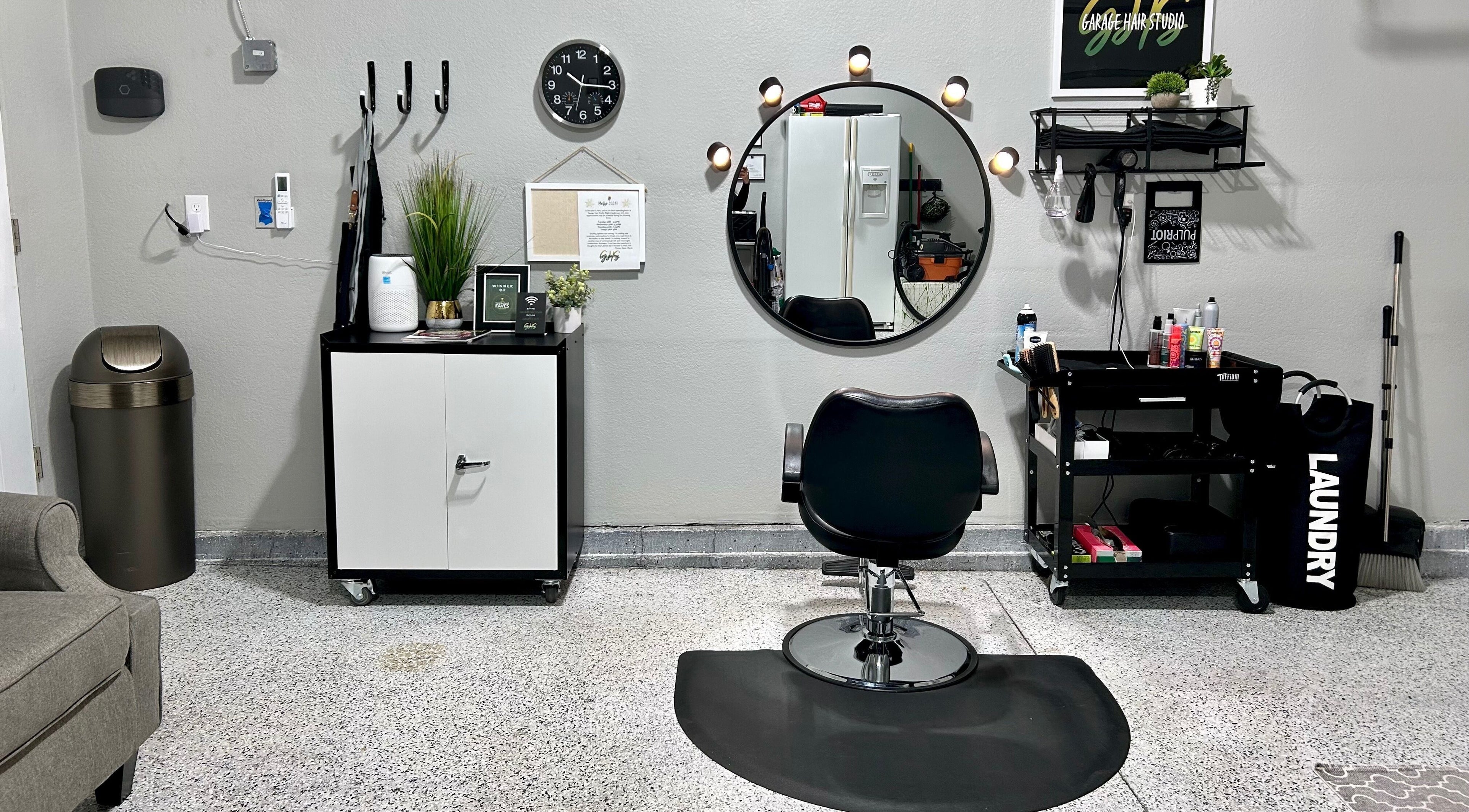 Modern salon chair and mirror setup at Lock + Root Hair Co., Frederick, Colorado, US.