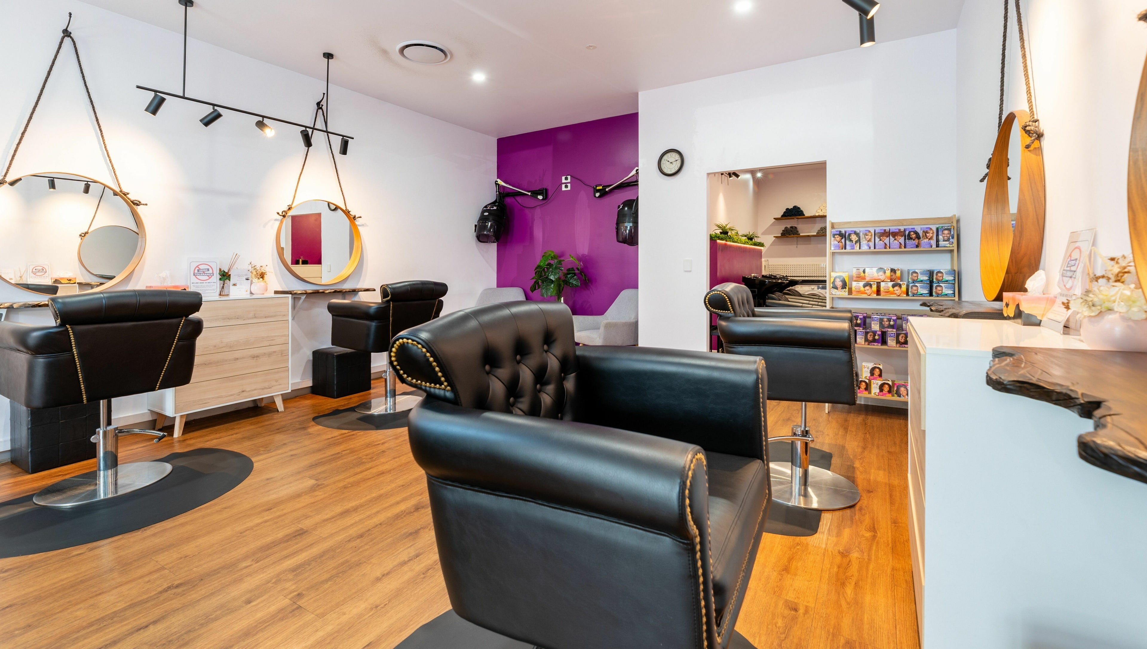 Totoya African Hair in Richlands, Queensland features chic styling chairs and vibrant decor.