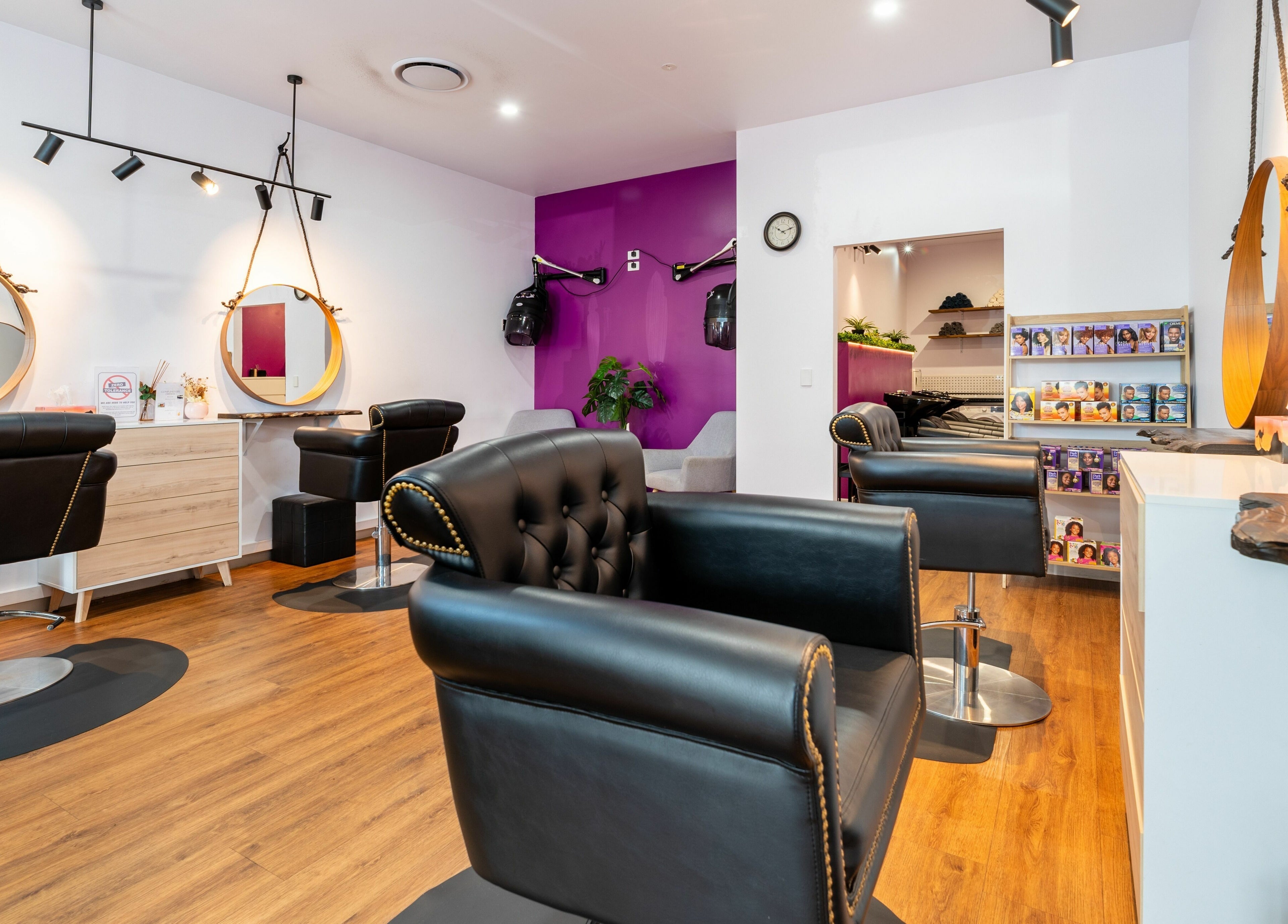 Totoya African Hair in Richlands, Queensland features chic styling chairs and vibrant decor.