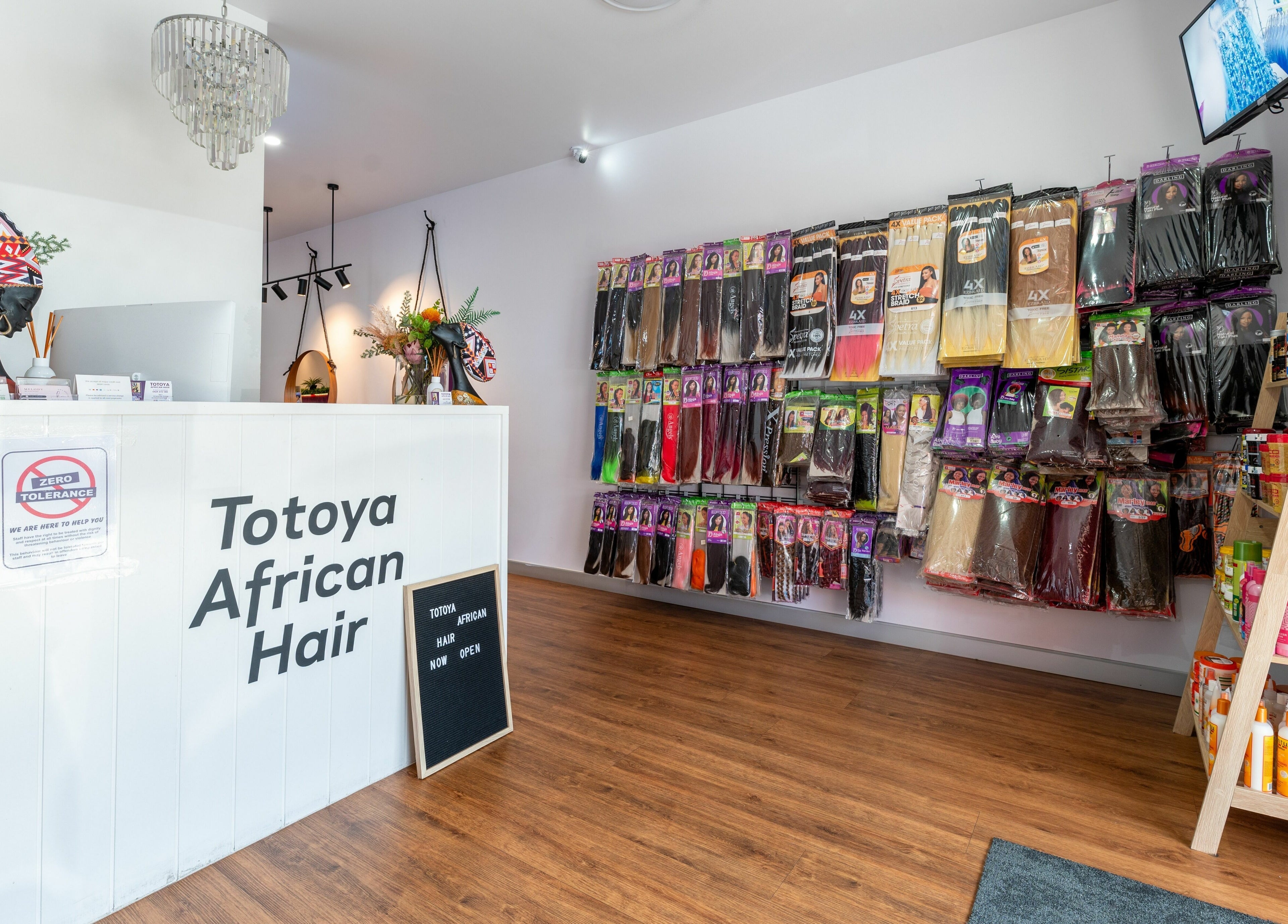 Interior of Totoya African Hair store, Richlands, QLD showcasing hair extensions and vibrant decor.