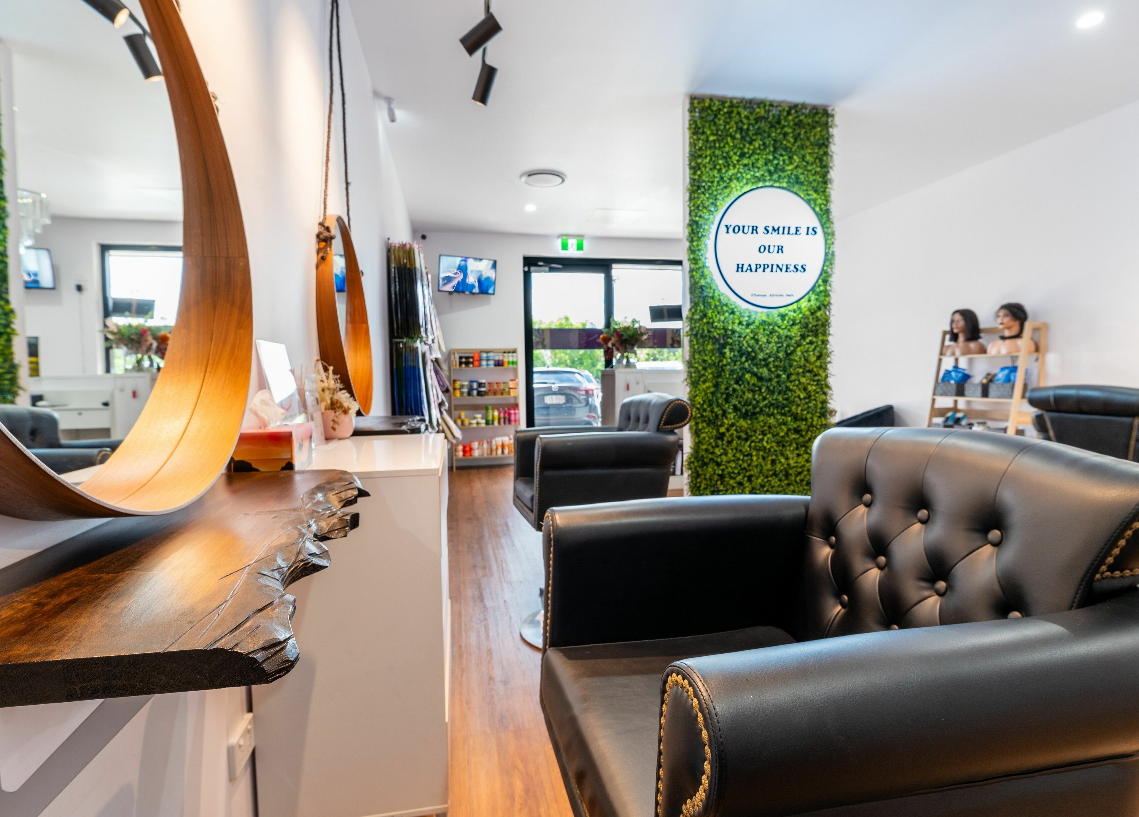 Modern salon interior at Totoya African Hair, Richlands, Queensland, AU showcasing chic decor and comfortable seating.
