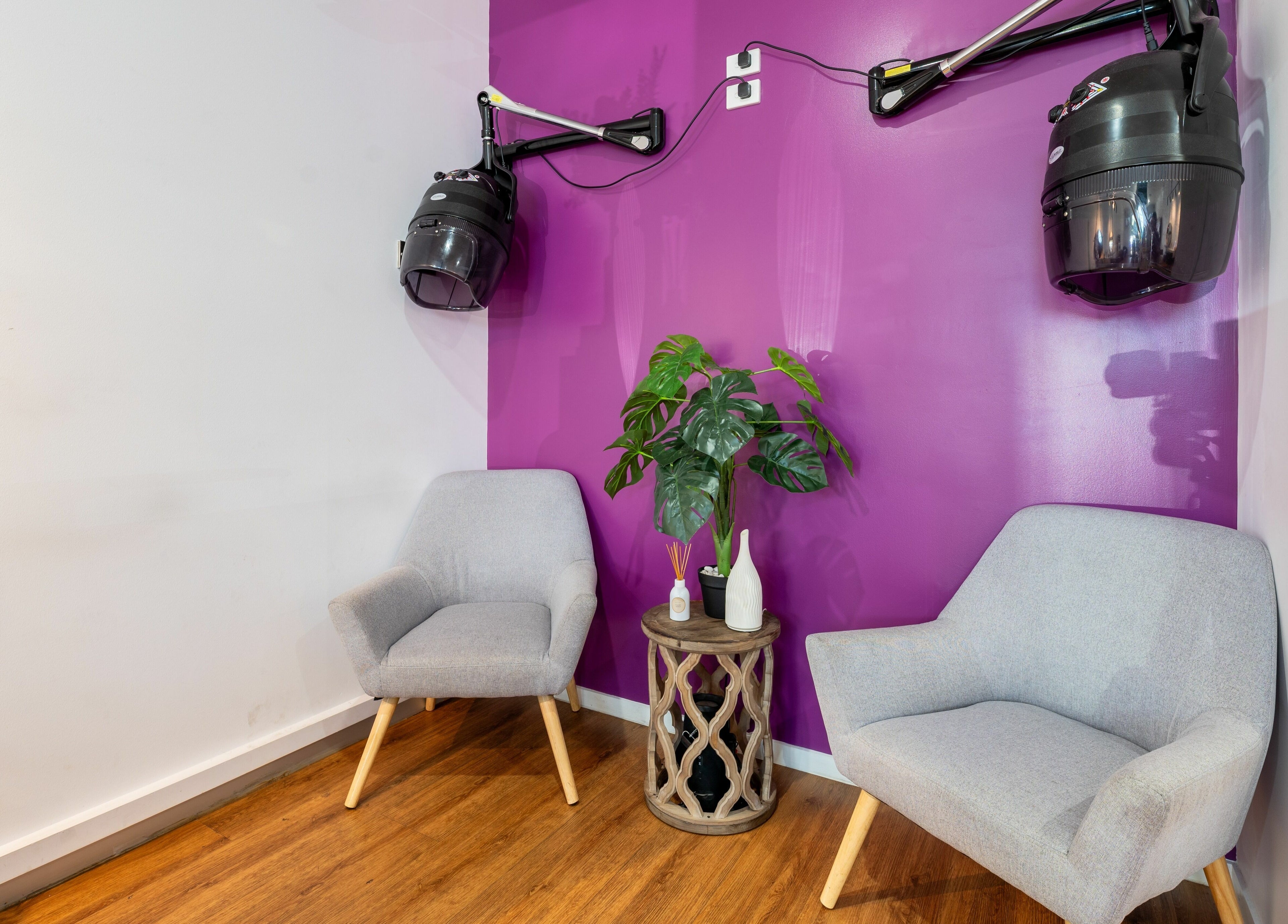 Relaxing seating area at Totoya African Hair, Richlands, Queensland, AU with modern chairs and vibrant decor.