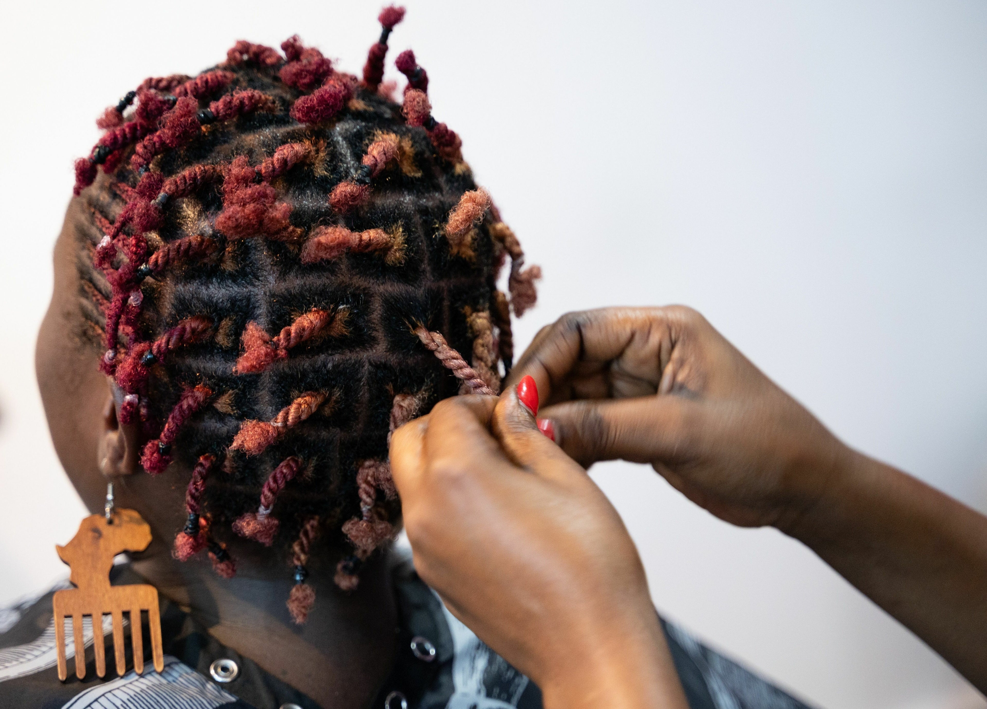 Stylist creates vibrant twists at Totoya African Hair, Richlands, Queensland, AU.
