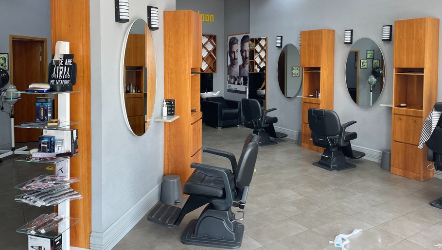 Interior of Volume Gents Salon in Dubai, AE showcasing sleek barber chairs and mirrors.
