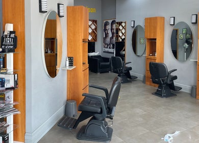 Interior of Volume Gents Salon in Dubai, AE showcasing sleek barber chairs and mirrors.