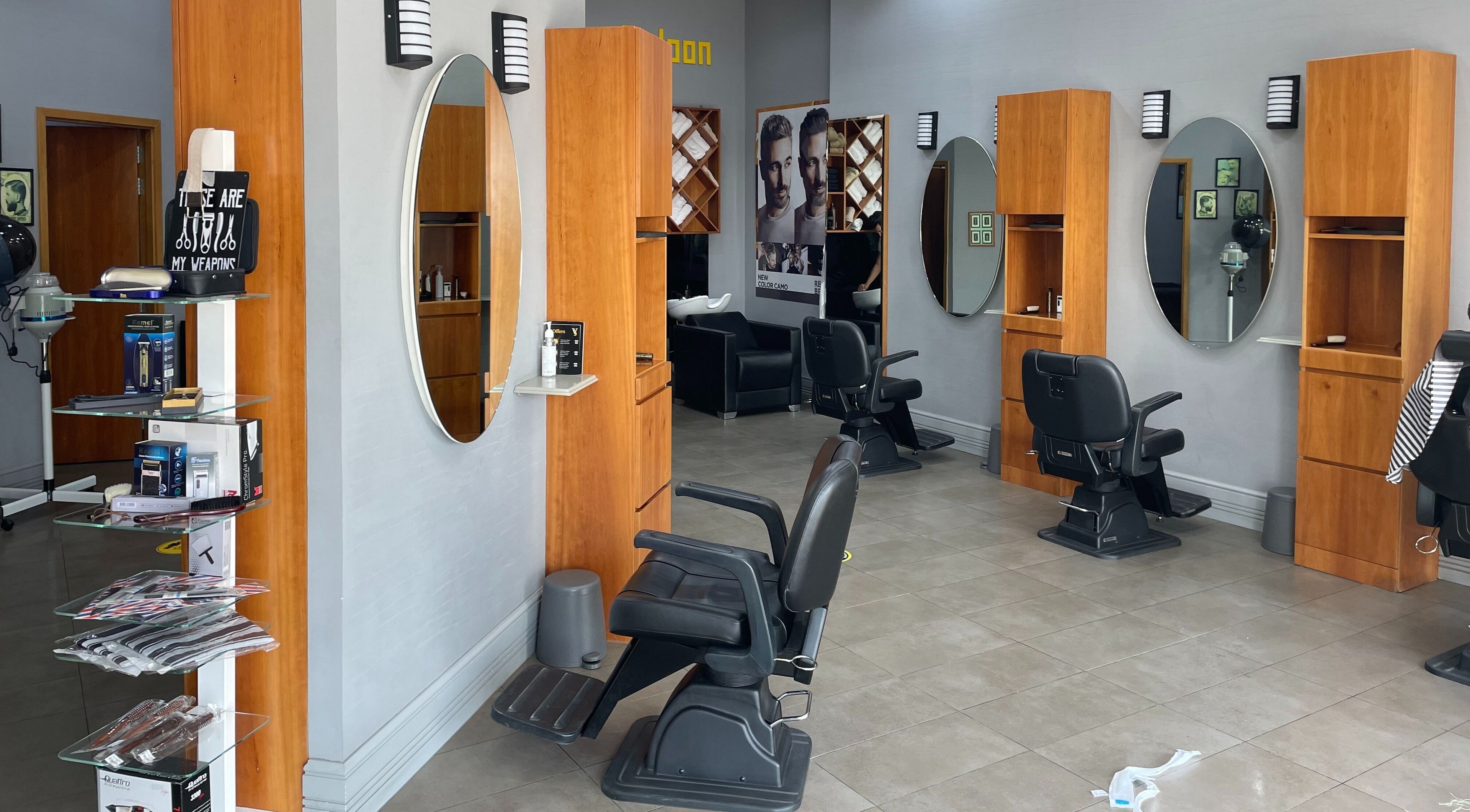 Interior of Volume Gents Salon in Dubai, AE showcasing sleek barber chairs and mirrors.