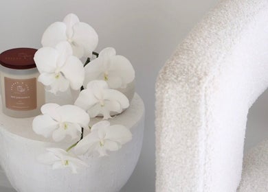 Elegant white orchids and candle at Bloom Beauty By Lauren, Camden, New South Wales, AU.