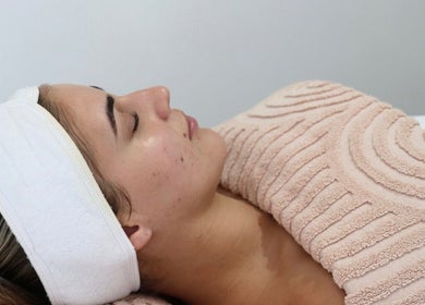 Relaxed client enjoying facial treatment at Bloom Beauty By Lauren, Camden, New South Wales, AU.