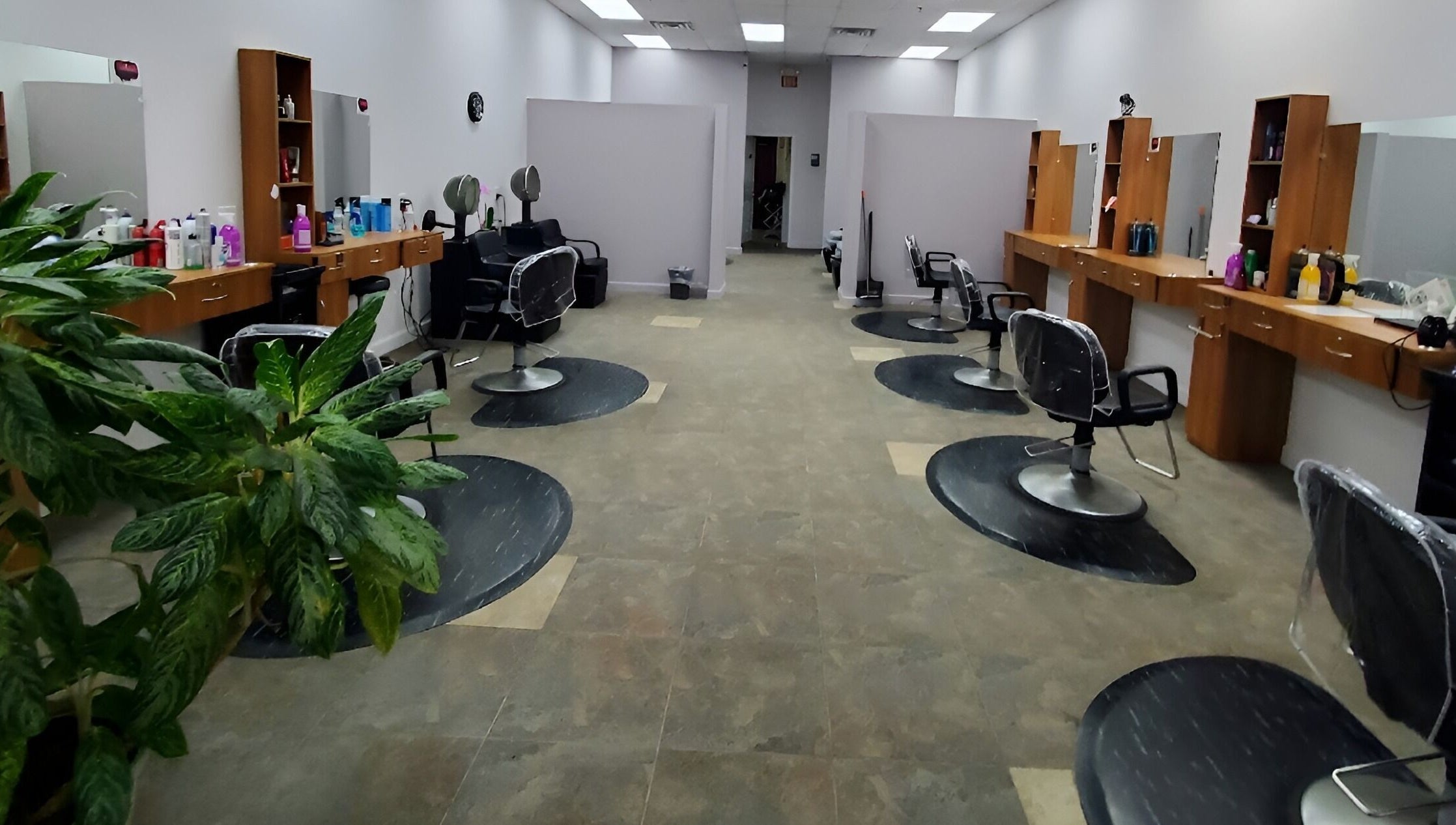 Stylish salon interior at Illusions Salon Co, Round Lake, Illinois, US with modern chairs and vibrant decor.