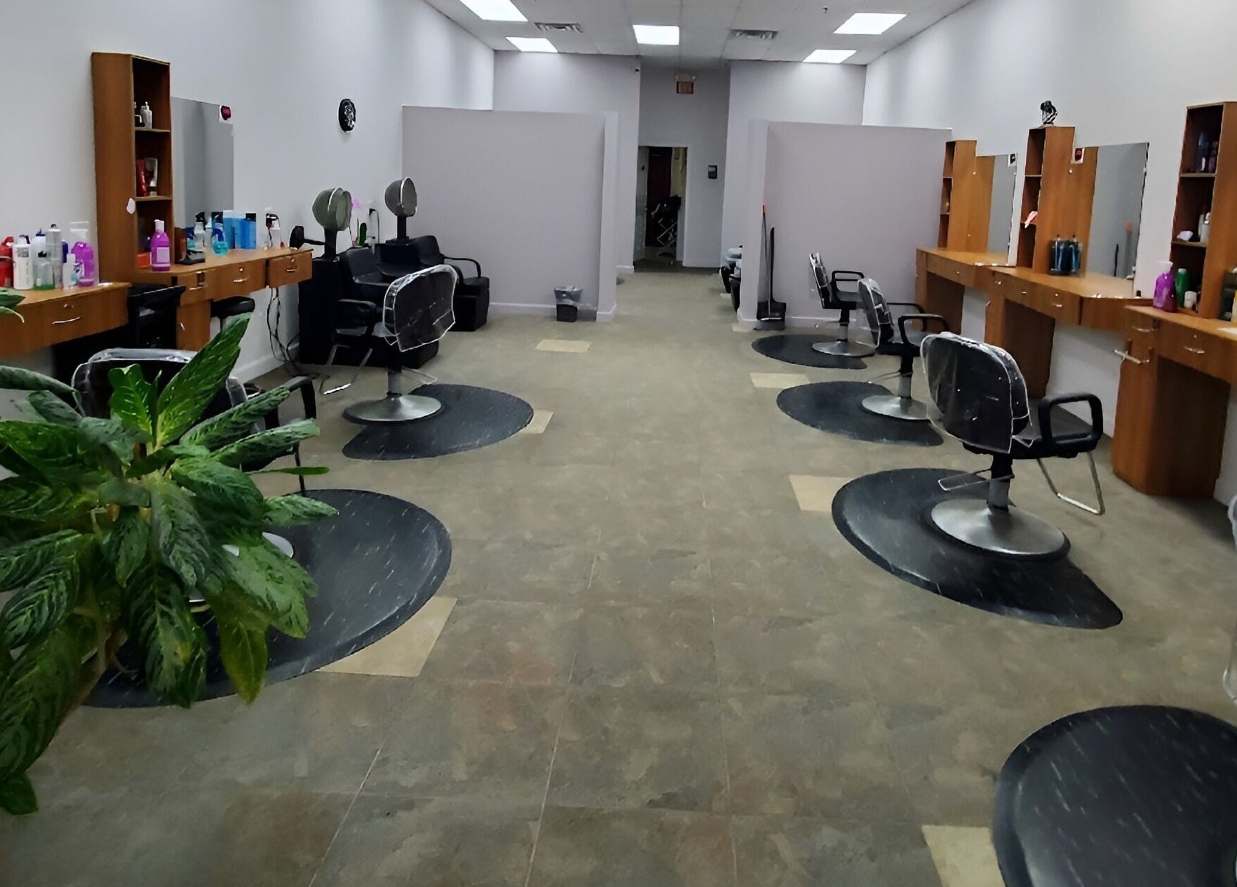 Stylish salon interior at Illusions Salon Co, Round Lake, Illinois, US with modern chairs and vibrant decor.
