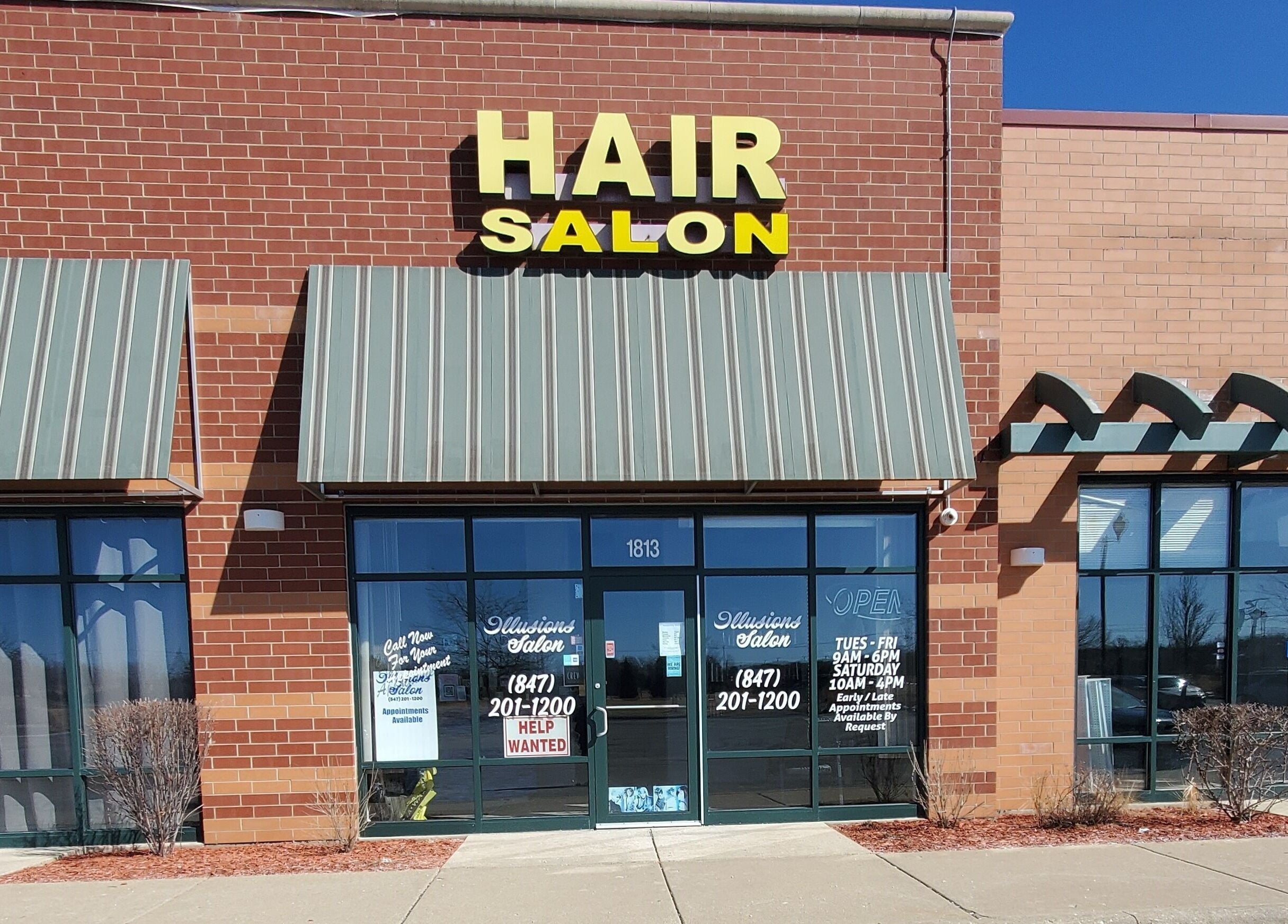 Illusions Salon Co entrance in Round Lake, Illinois, US, showcasing a clean modern facade.