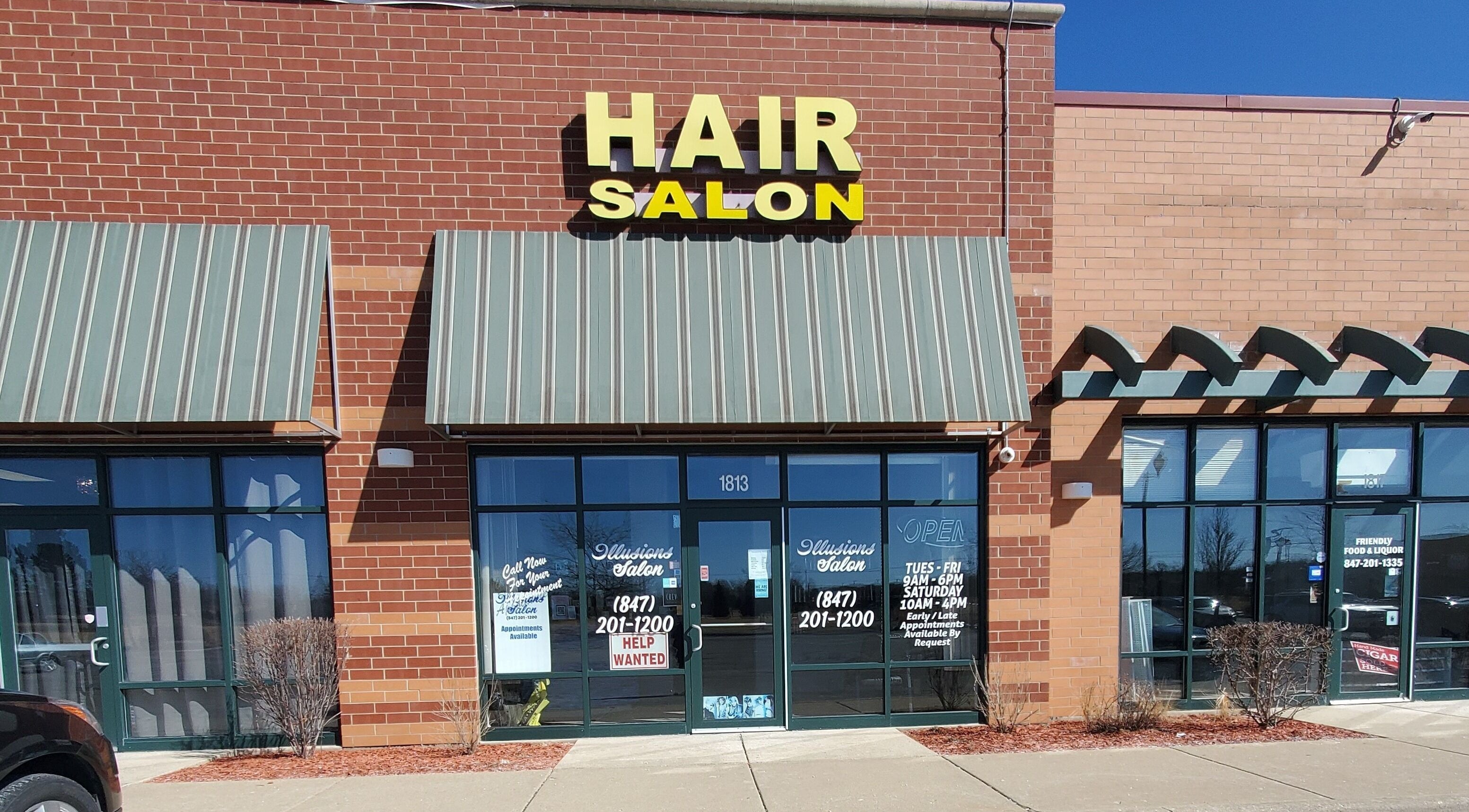 Illusions Salon Co entrance in Round Lake, Illinois, US, showcasing a clean modern facade.