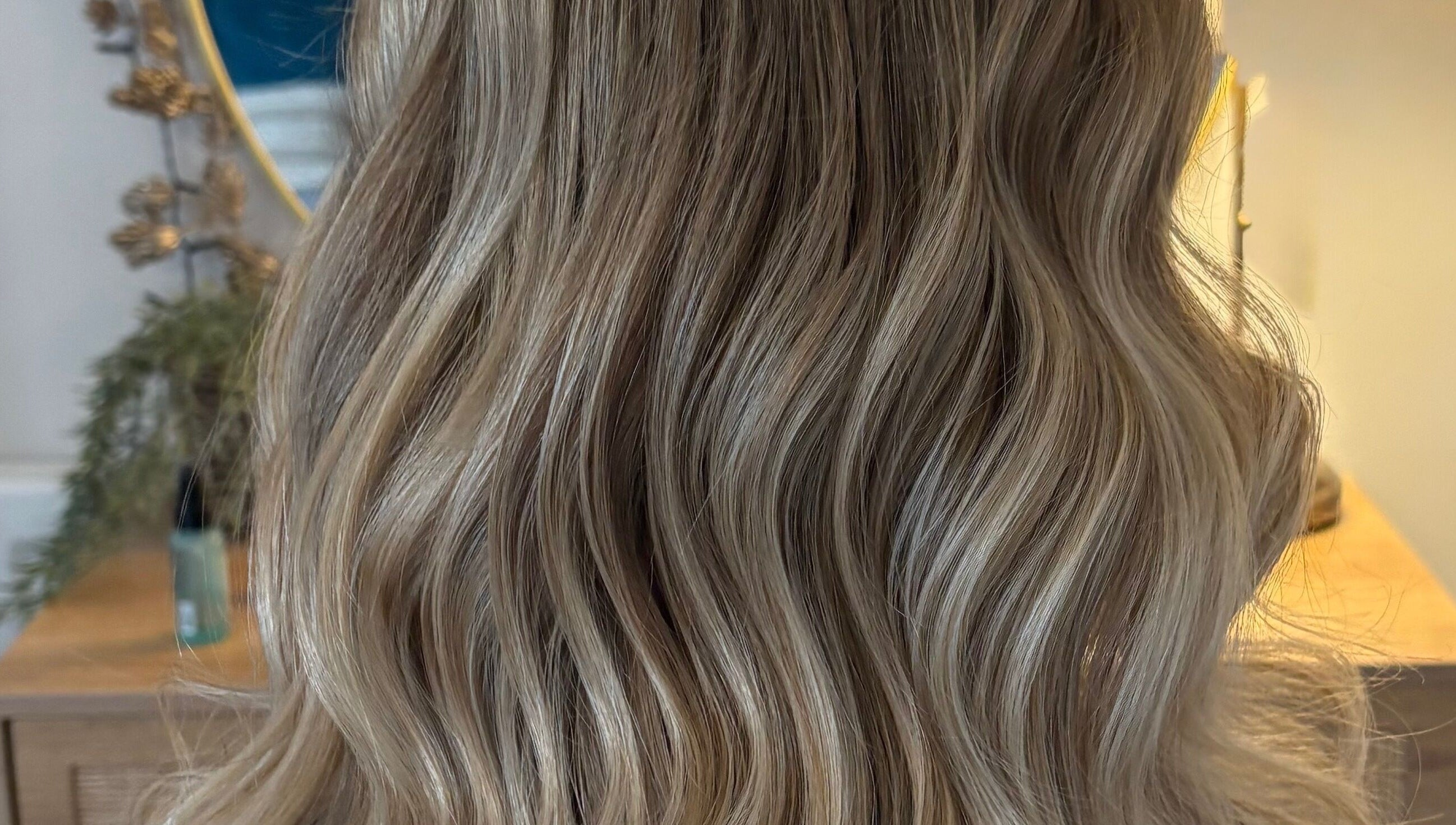 Glossy blonde waves styled at Hairbysarah salon in Chichester, England, GB.