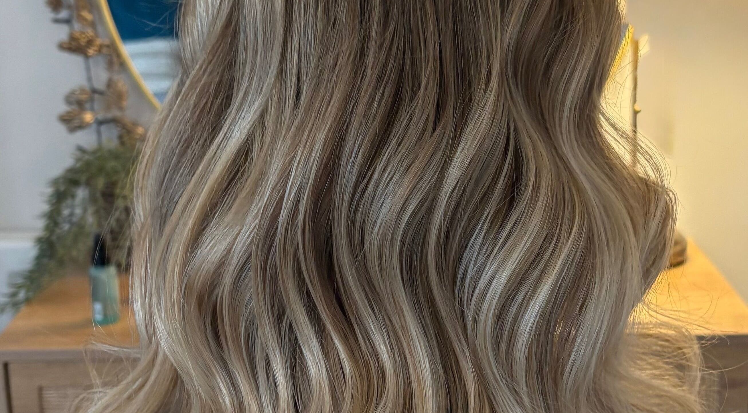 Glossy blonde waves styled at Hairbysarah salon in Chichester, England, GB.