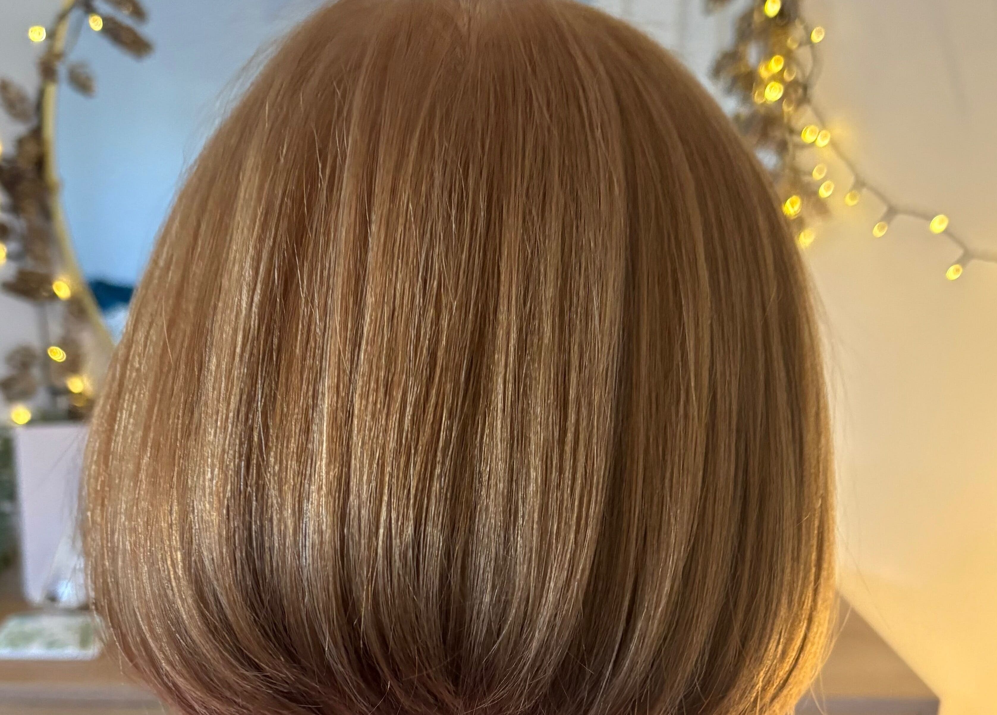 Elegant bob hairstyle at Hairbysarah in Chichester, England, GB, reflecting warm, golden tones.