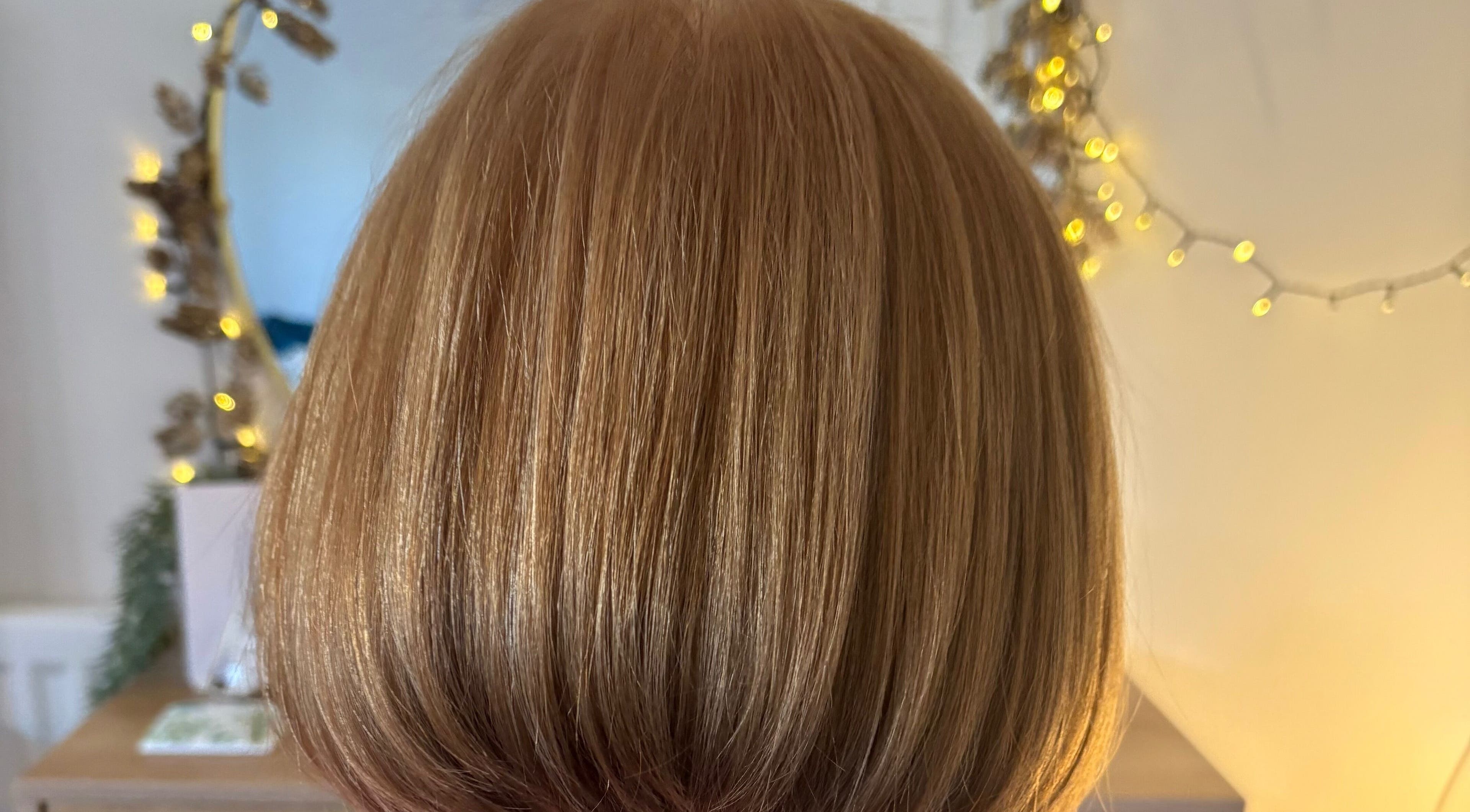 Elegant bob hairstyle at Hairbysarah in Chichester, England, GB, reflecting warm, golden tones.