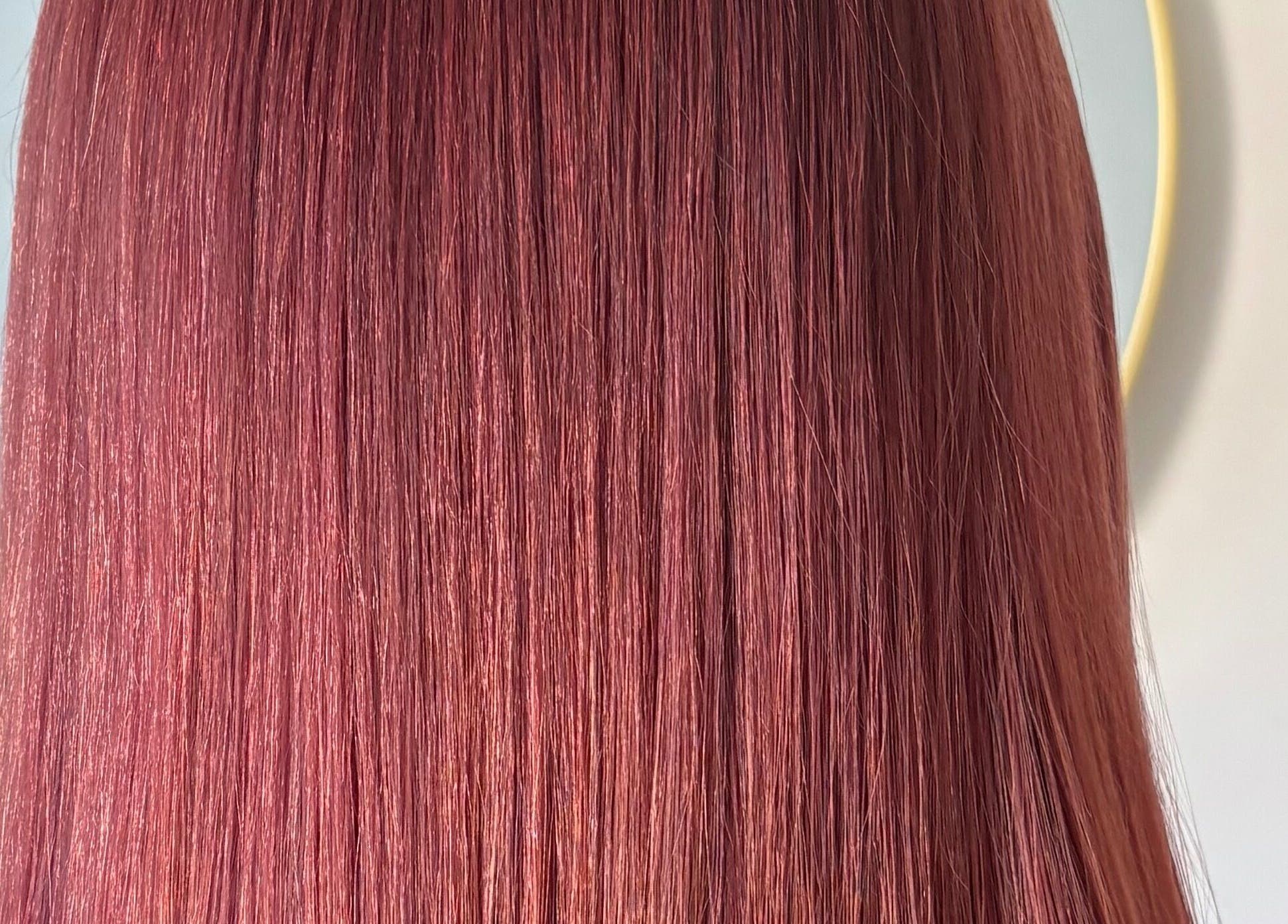 Sleek, vibrant red hair showcasing professional styling at Hairbysarah, Chichester, England, GB.