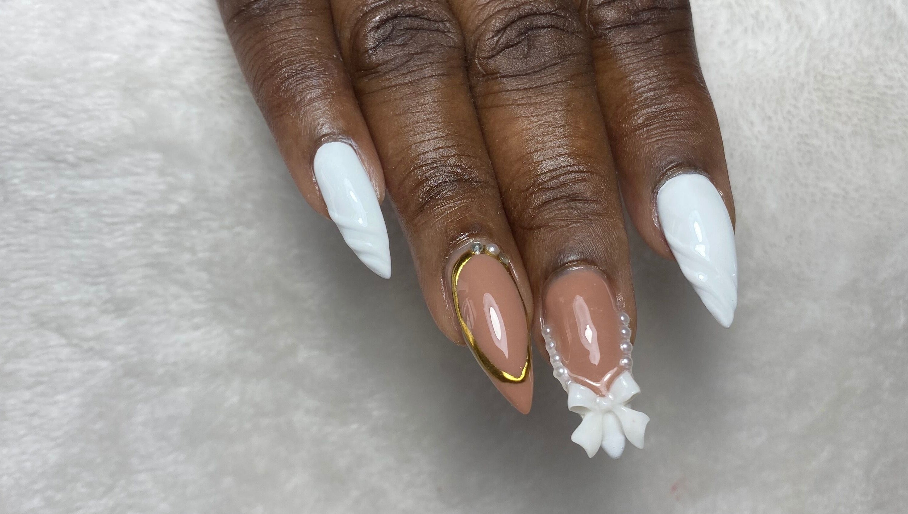 Chic nail art with white and nude polish at Reign Nail Studio, Saint Michael, BB.