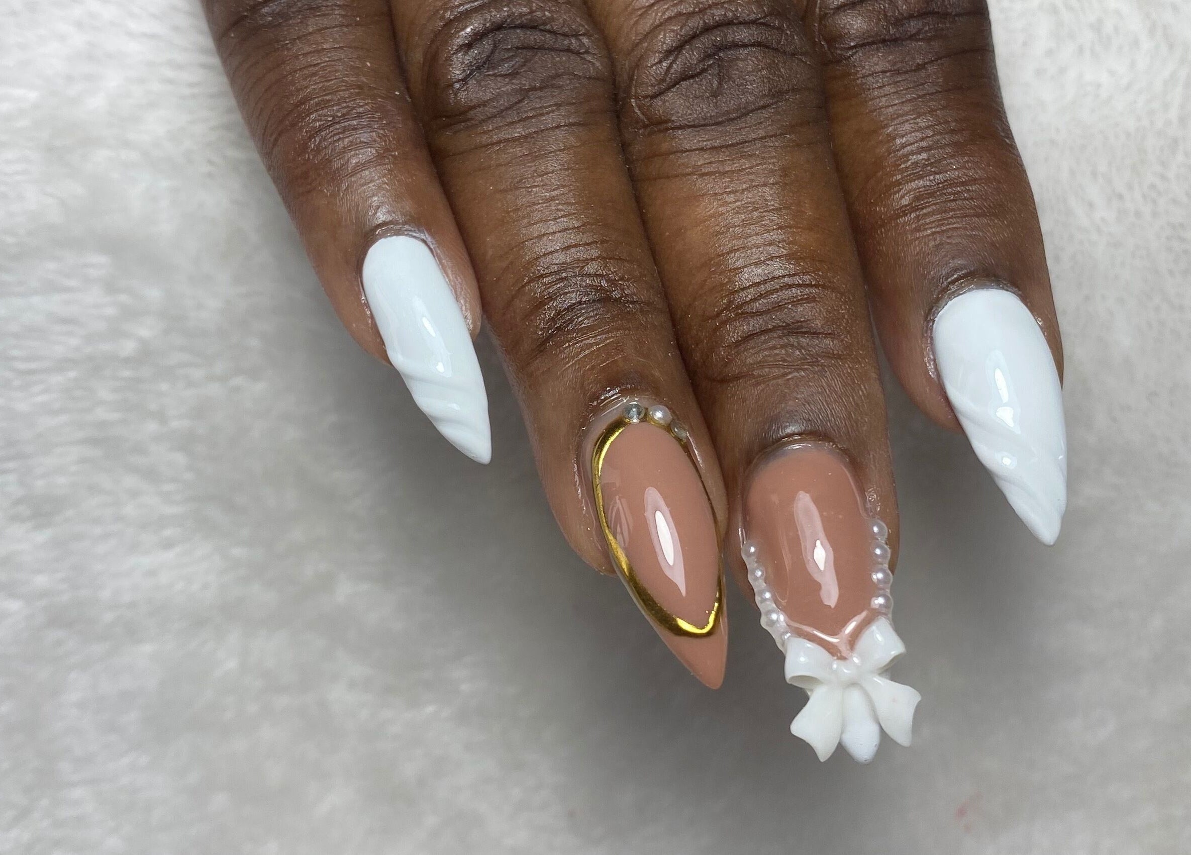 Chic nail art with white and nude polish at Reign Nail Studio, Saint Michael, BB.