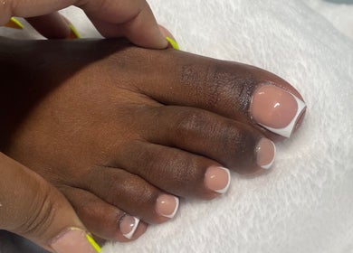 Fresh French pedicure at Reign Nail Studio, Saint Michael, Saint Michael, BB. Perfectly styled toes on white towel.
