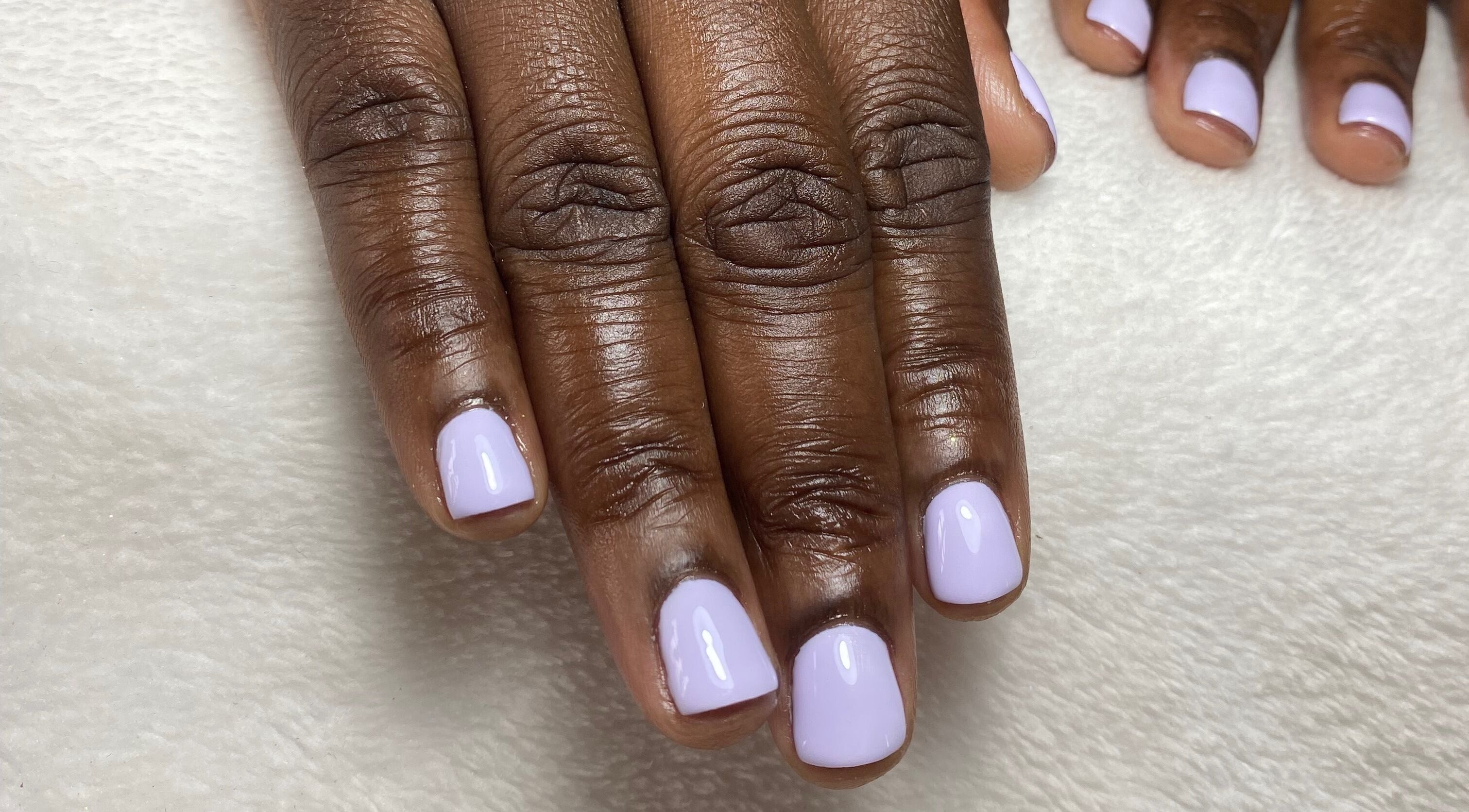 Lavender nail art at Reign Nail Studio, Saint Michael, BB. Perfectly polished nails on a cozy backdrop.