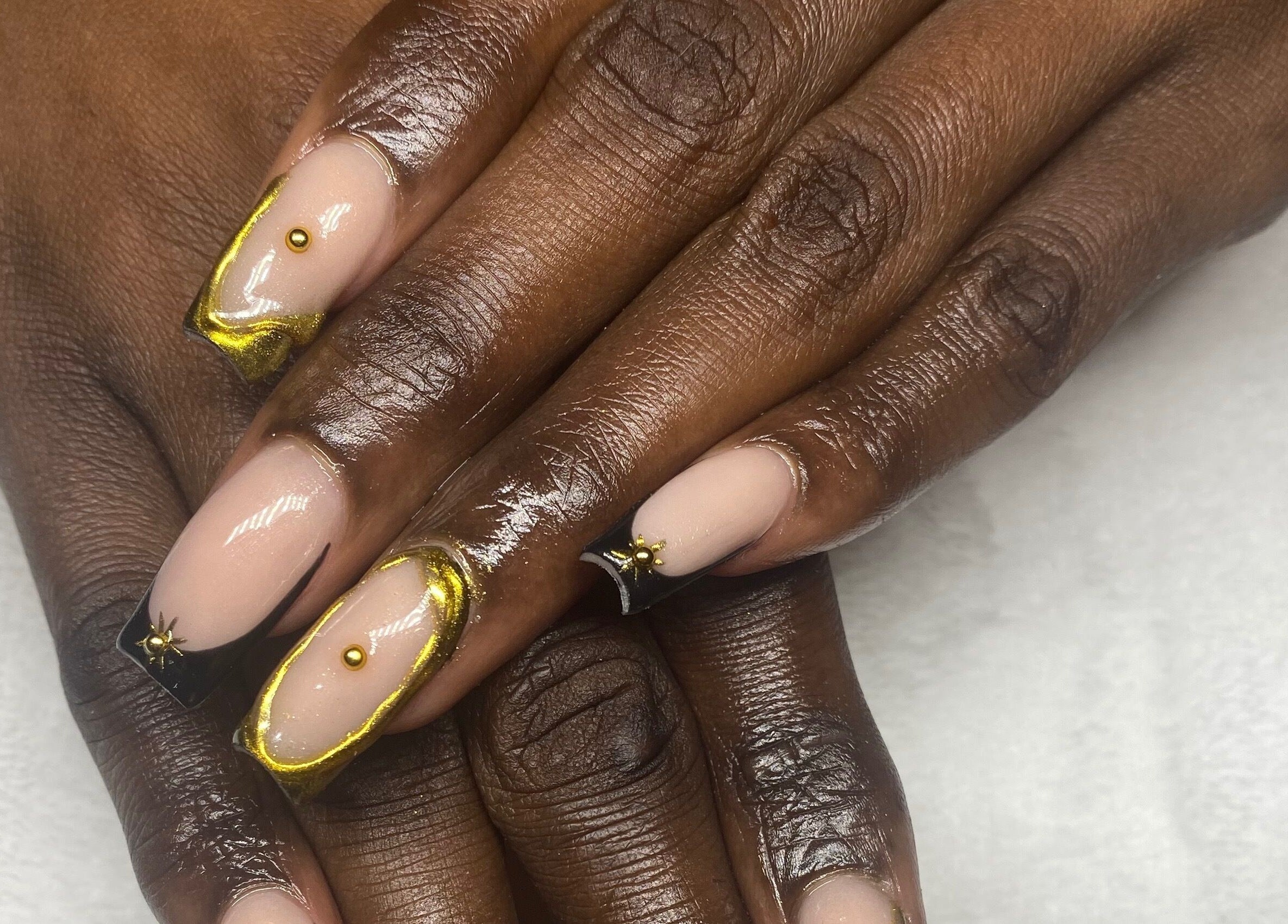Elegant manicure with gold accents at Reign Nail Studio, Saint Michael, BB.