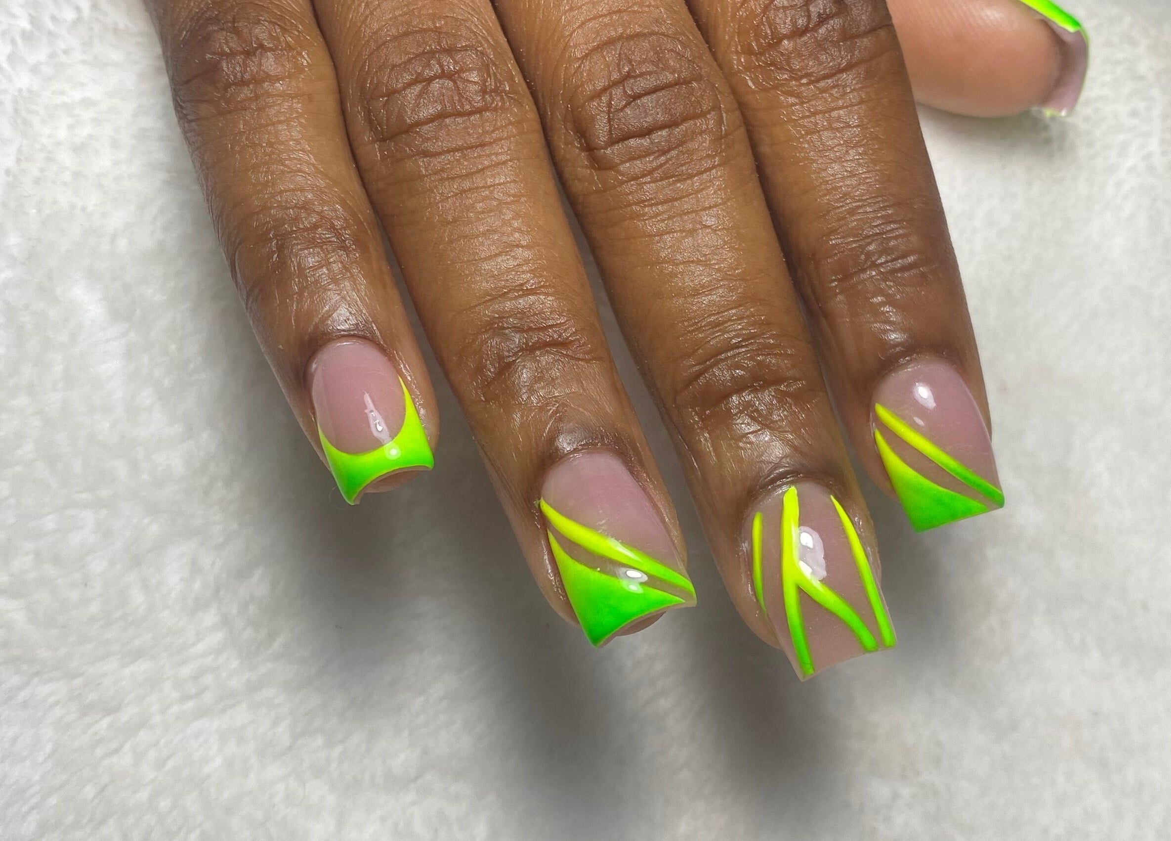 Lime green neon nail art at Reign Nail Studio, Saint Michael, BB. Showcase of unique manicure style.