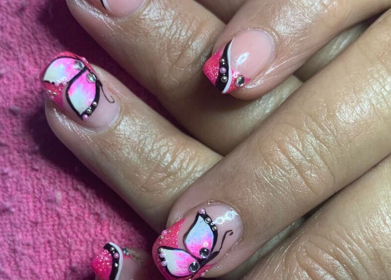 Butterfly nail art at Nadia’s Nails, Newcastle, KwaZulu-Natal, ZA featuring pink accents and intricate designs.
