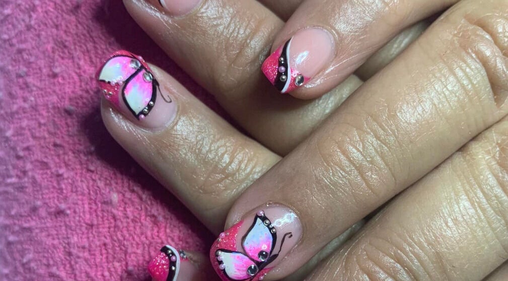 Butterfly nail art at Nadia’s Nails, Newcastle, KwaZulu-Natal, ZA featuring pink accents and intricate designs.