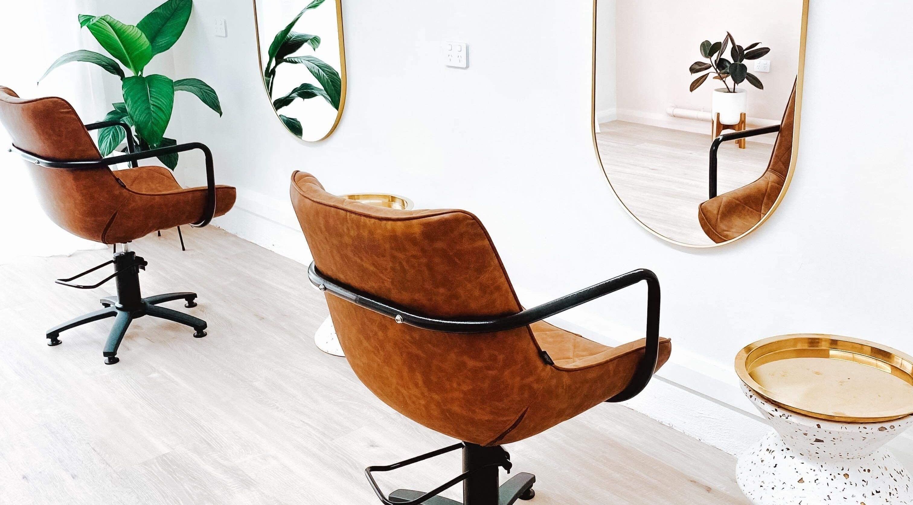 Modern salon chairs and mirrors at Amanda Rainey Hair in Tahmoor, New South Wales, AU with stylish decor.