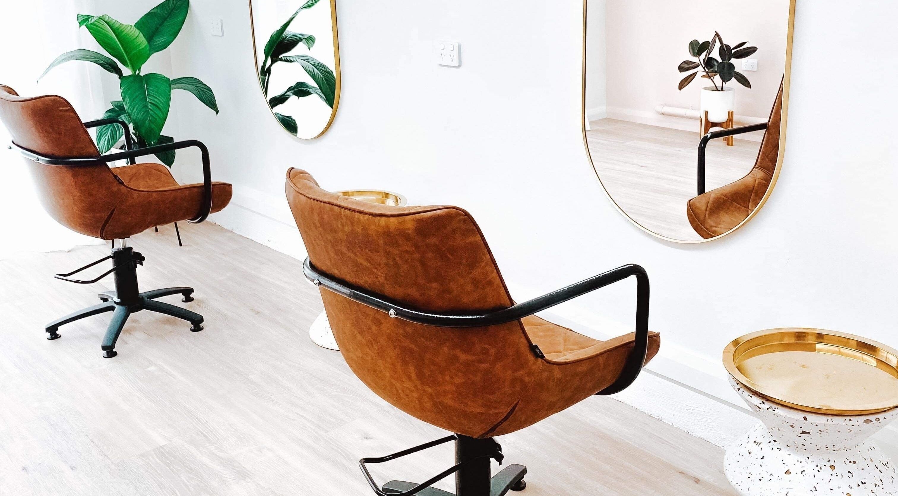 Modern salon chairs and mirrors at Amanda Rainey Hair in Tahmoor, New South Wales, AU with stylish decor.