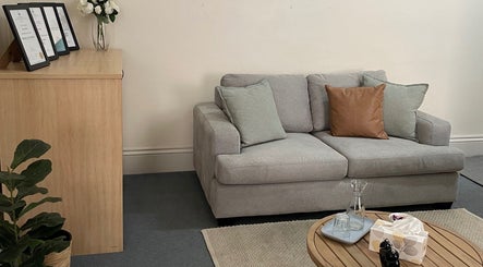 Cozy lounge area at Absolute Wellbeing Mind & Body Pty Ltd, Ballarat Central, Victoria, AU featuring a gray sofa.