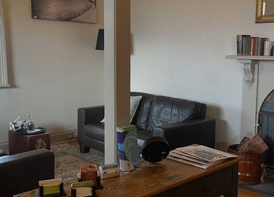 Inviting lounge at Absolute Wellbeing Mind & Body Pty Ltd, Ballarat Central, Victoria, AU with leather sofas and fireplace.