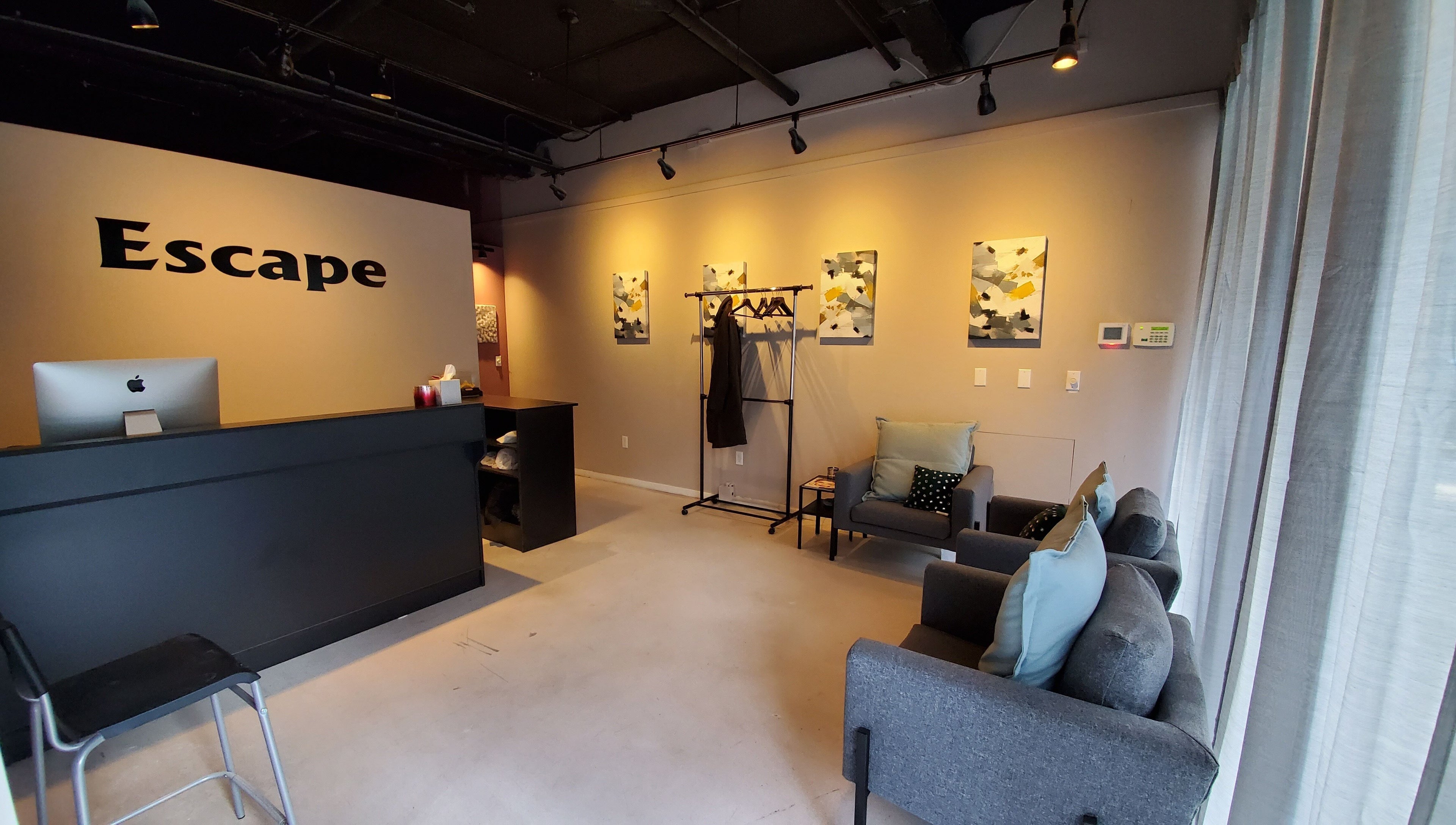 Modern reception area at ESCAPE, New York, New York, US, with stylish decor and cozy seating.