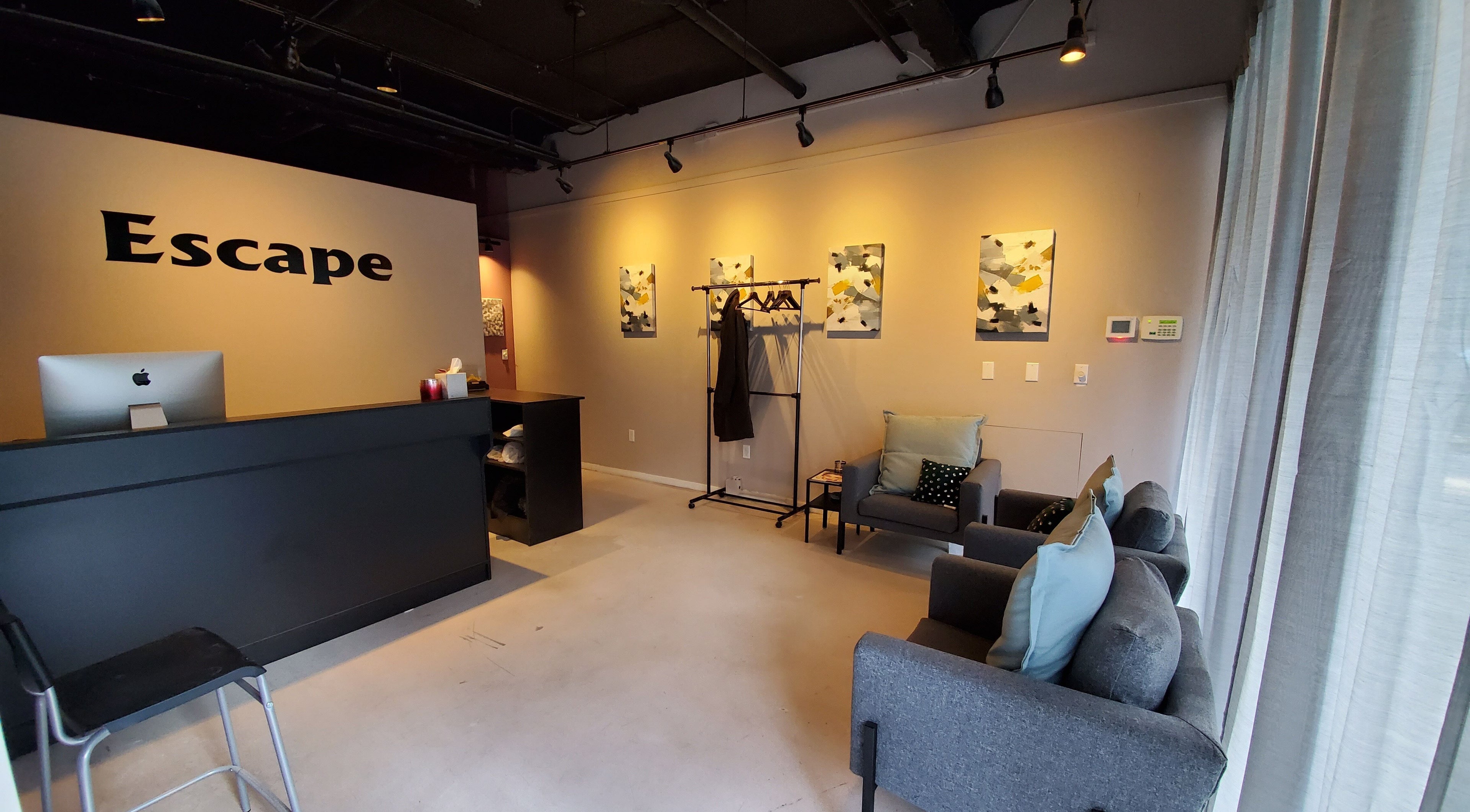 Modern reception area at ESCAPE, New York, New York, US, with stylish decor and cozy seating.