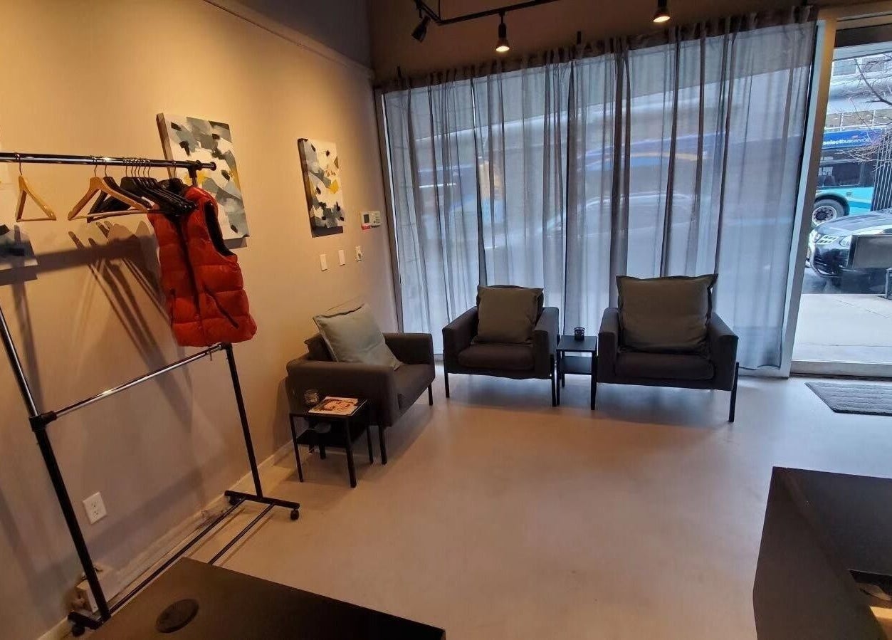 Cozy seating area in ESCAPE, a wellness venue in New York, New York, US, featuring chairs and art.