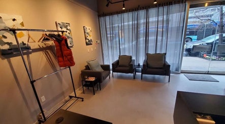 Cozy seating area in ESCAPE, a wellness venue in New York, New York, US, featuring chairs and art.