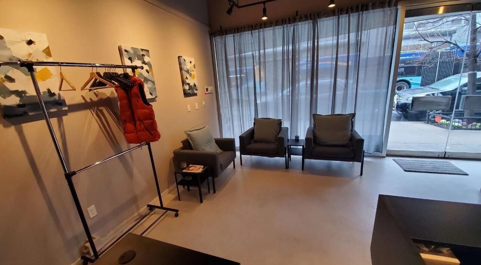 Cozy seating area in ESCAPE, a wellness venue in New York, New York, US, featuring chairs and art.