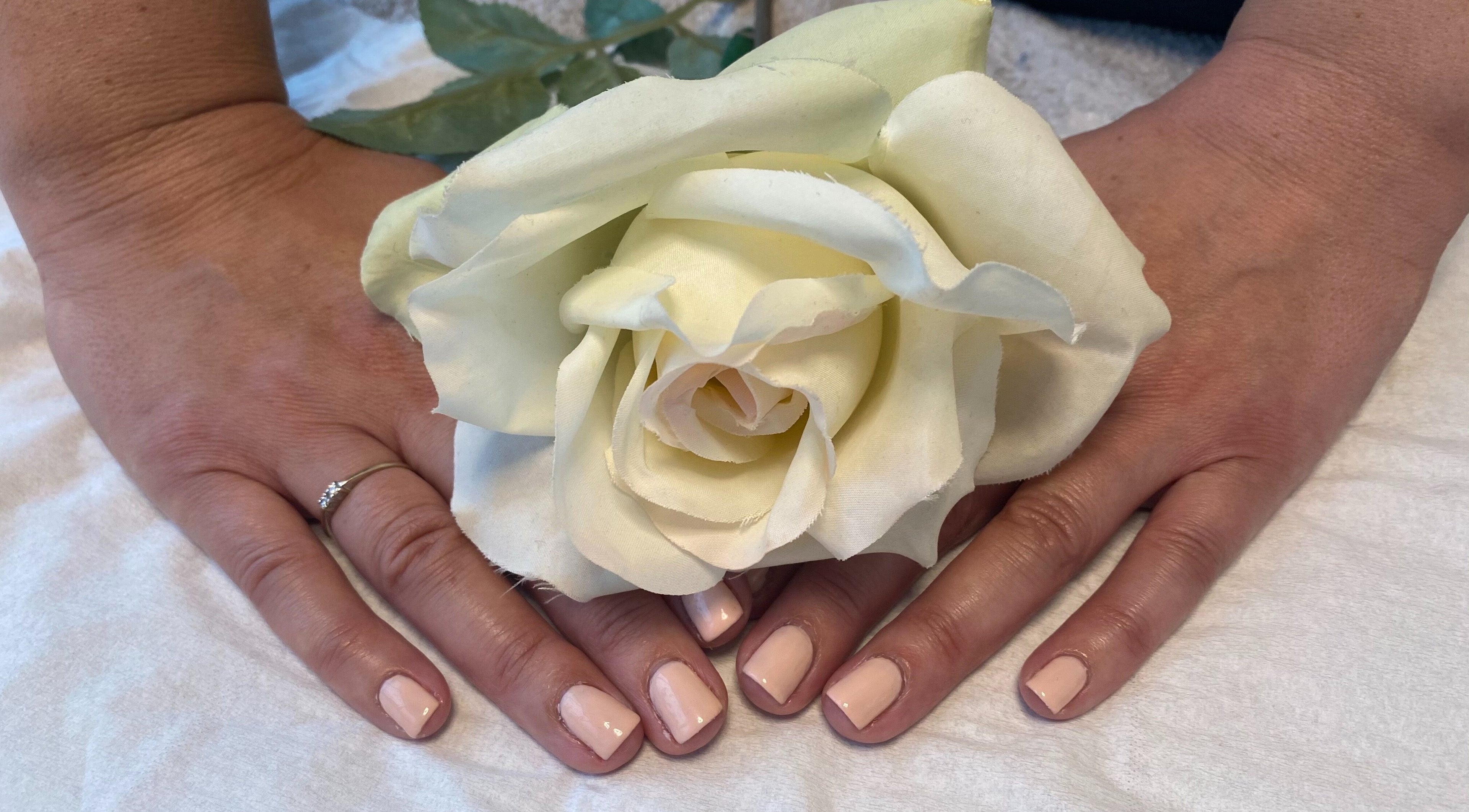 Stylish nude manicure with white rose at ABTN CLINIC, Sittingbourne, England, GB.
