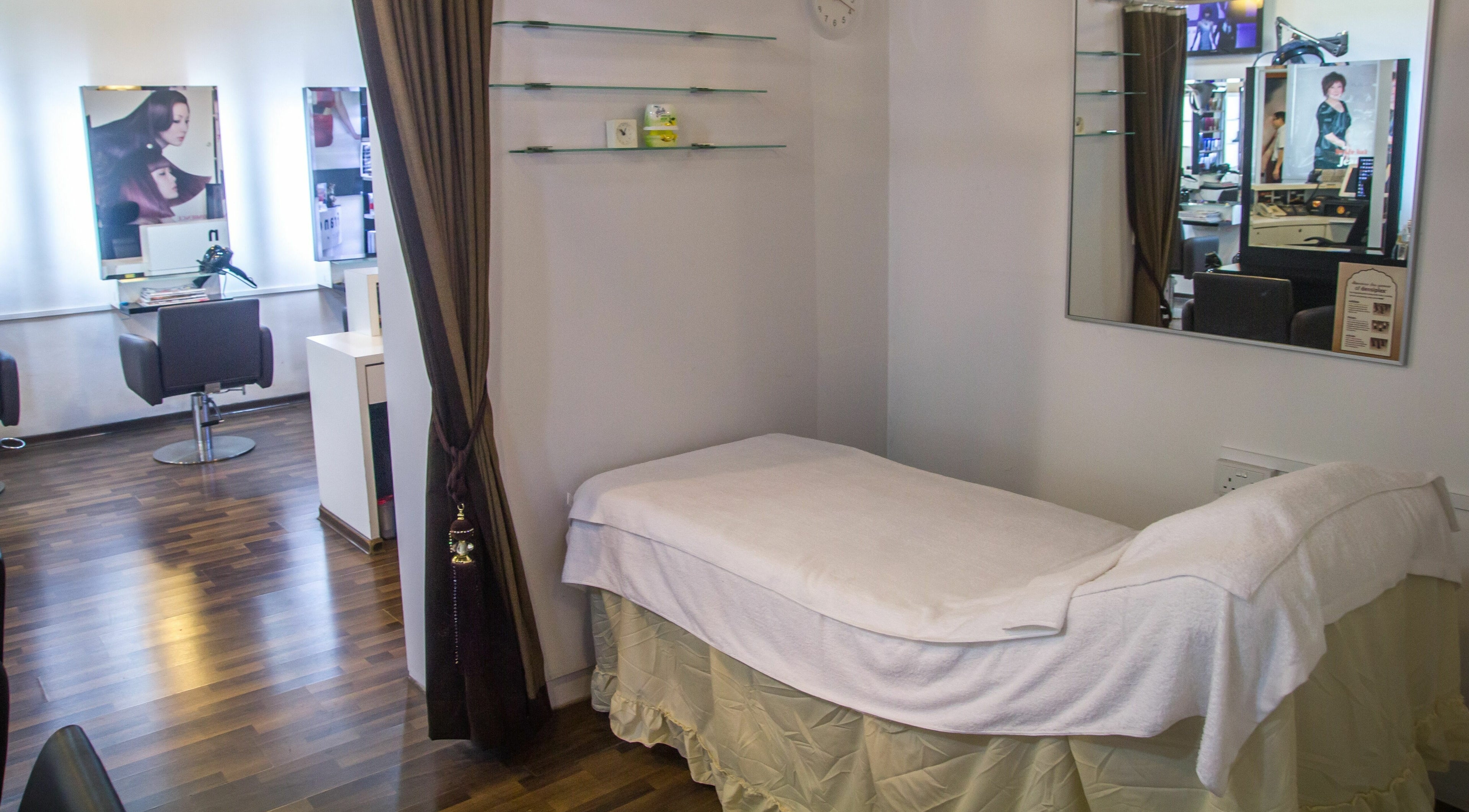 Cozy spa room at Francis and Jean, Singapore, SG with elegant décor and plush treatment bed.