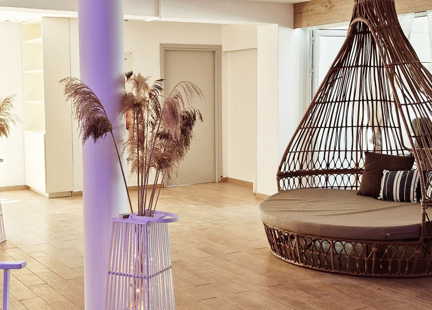 Relaxing lounge area at Blue Spa, Nausicaa Beach Hotel, Protaras, Ammochostos, CY, featuring a wicker chair.