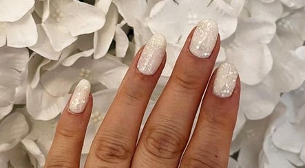 Sparkling white nails against white flowers at Beauty by B, Market Deeping, England, GB.
