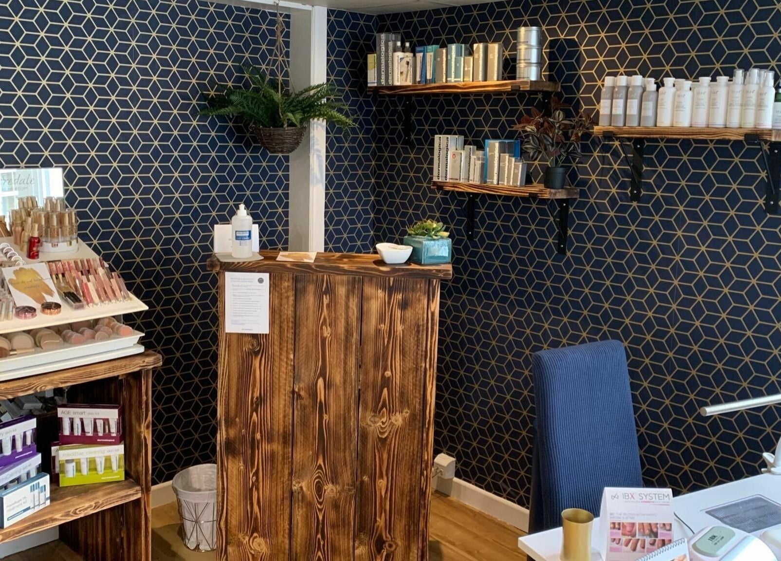 Cozy reception area at Calmante, Truro, England, GB, featuring elegant decor with beauty products displayed.