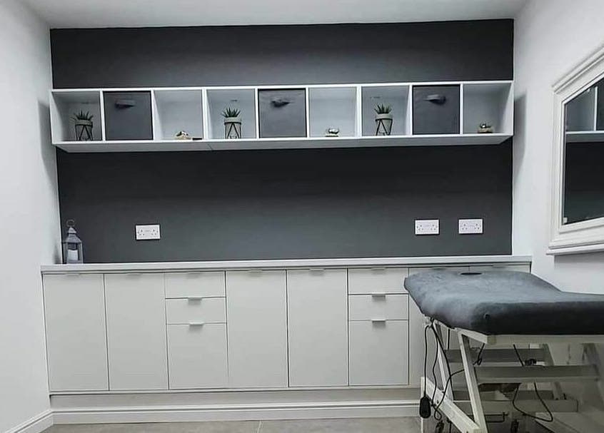 Relaxing therapy room at Hairitage, Hull, England, GB featuring sleek modern decor and massage table.