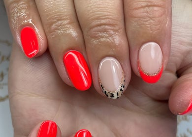 Stylish nail art with vibrant coral and leopard accents at Polished Pinky's, Taverham, England, GB.