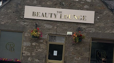 The Beauty Lounge exterior with stylish signage in Aberdeen, GB, showcasing rustic charm with floral accents.